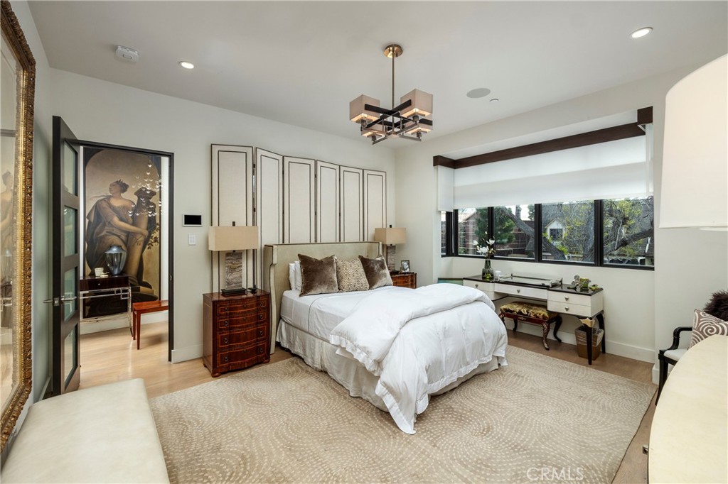 401 Snug Harbor Road Newport Beach, CA 92663 - Photo 24 of 35 a spacious bedroom with a bed and a chandelier