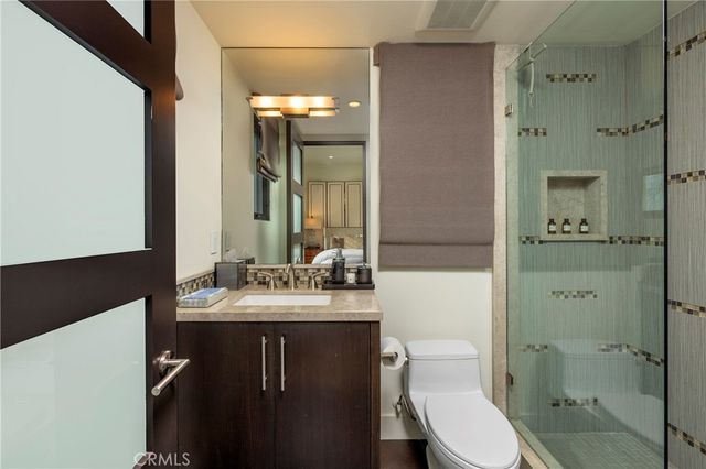 a bathroom with a sink a toilet and shower