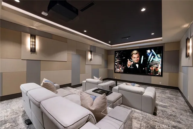 a living room with furniture a rug and a projector