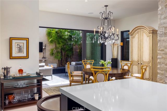 a living room with fireplace furniture and a chandelier