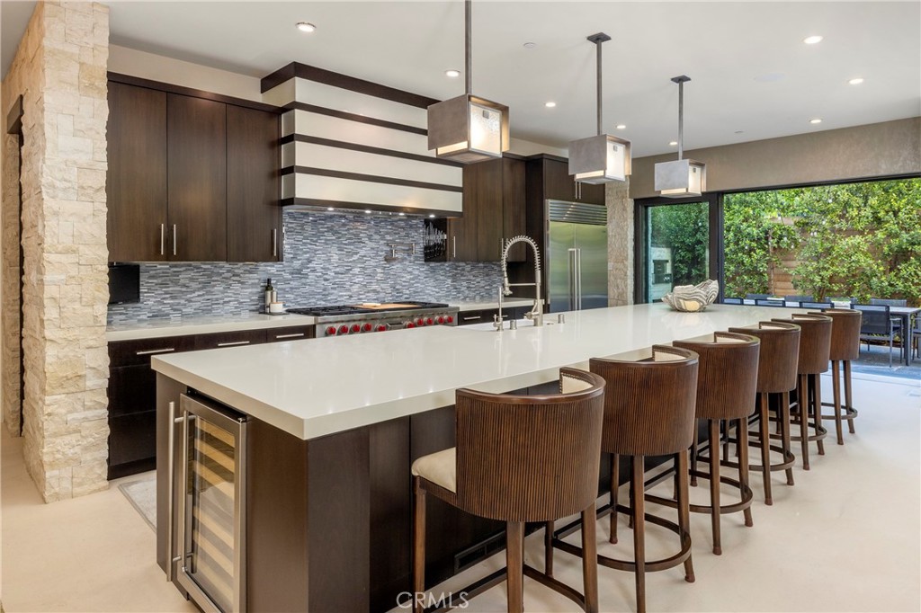 401 Snug Harbor Road Newport Beach, CA 92663 - Photo 7 of 35 a kitchen with a table chairs and sink