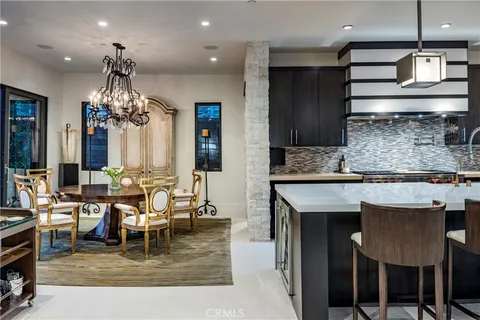 a living room with kitchen island furniture and a chandelier