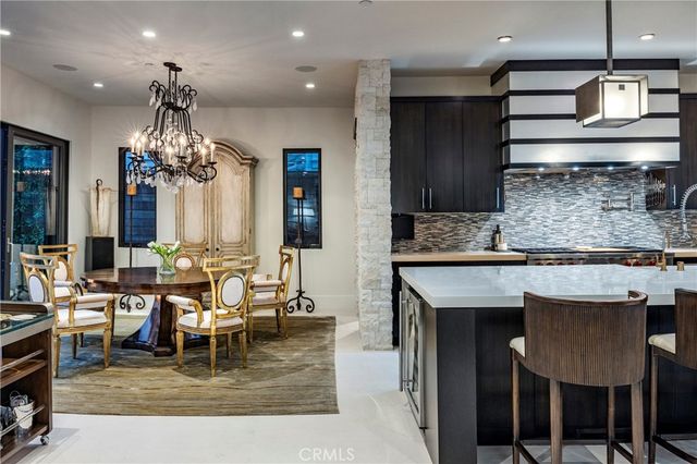 a living room with kitchen island furniture and a chandelier