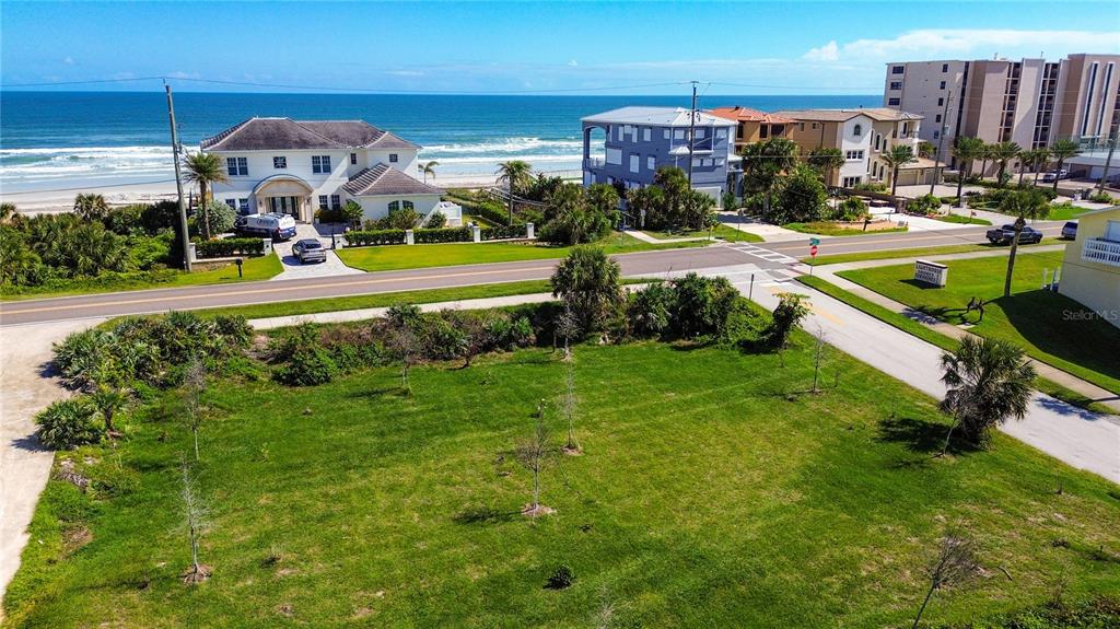 4736 South Atlantic Avenue Ponce Inlet, FL 32127 - Photo 11 of 32 a view of a swimming pool with lawn chairs and a big yard
