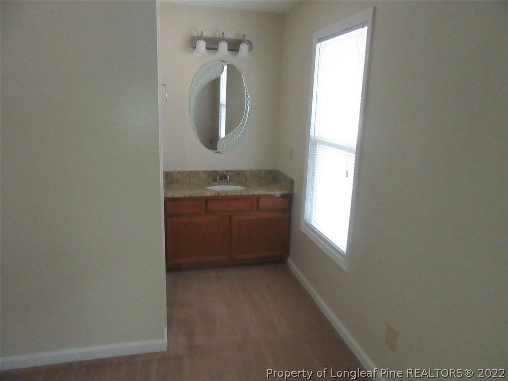 461 Camden Road Raeford, NC 28376 - Photo 12 of 18 a bathroom with a toilet a sink and mirror