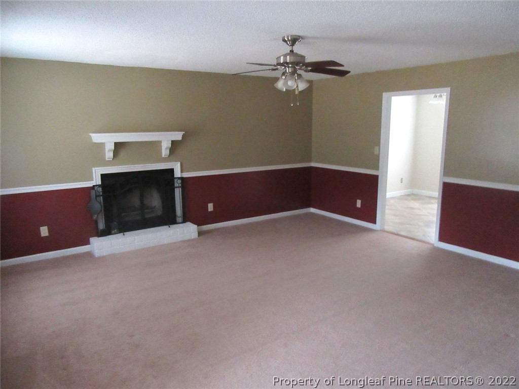 461 Camden Road Raeford, NC 28376 - Photo 5 of 18 a view of an empty room with a chandelier fan