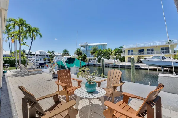 a dining room with furniture a rug and a chandelier