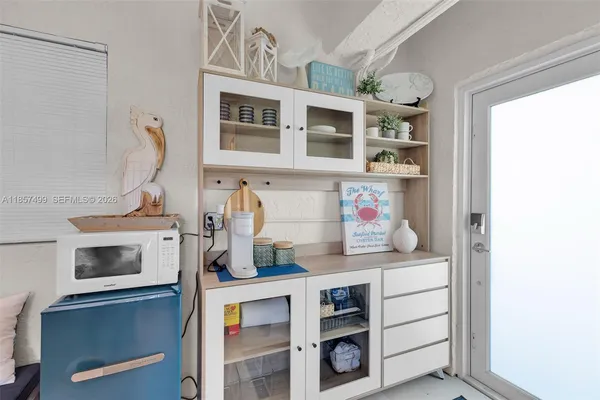 a large kitchen with kitchen island a stove a sink a center island and cabinets