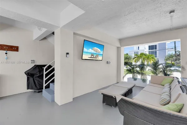 a kitchen with sink and view of living room