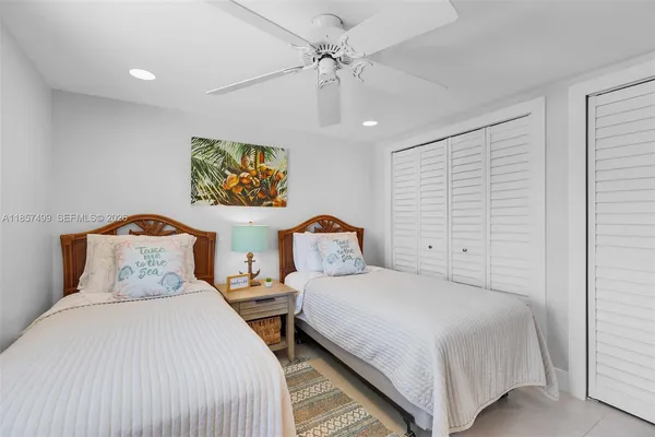 a row of palm trees and a yard of a house