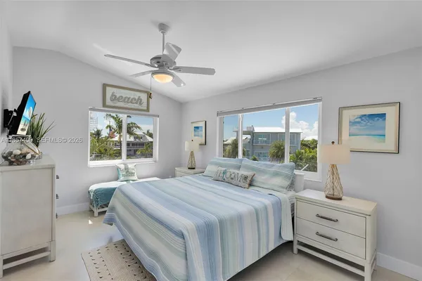 a view of a lake with boats and trees in the background