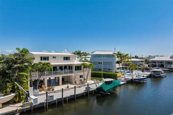 a living room with patio furniture and a potted plants