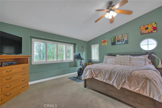 a view of a backyard with table and chairs potted plants and large tree