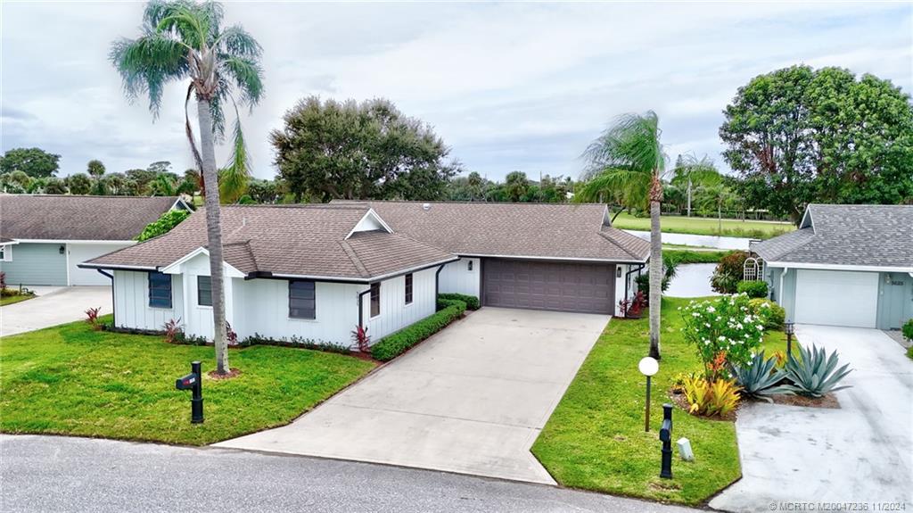 5635 Southeast Miles Grant Road Stuart, FL 34997 - Photo 1 of 73 front view of house with a yard