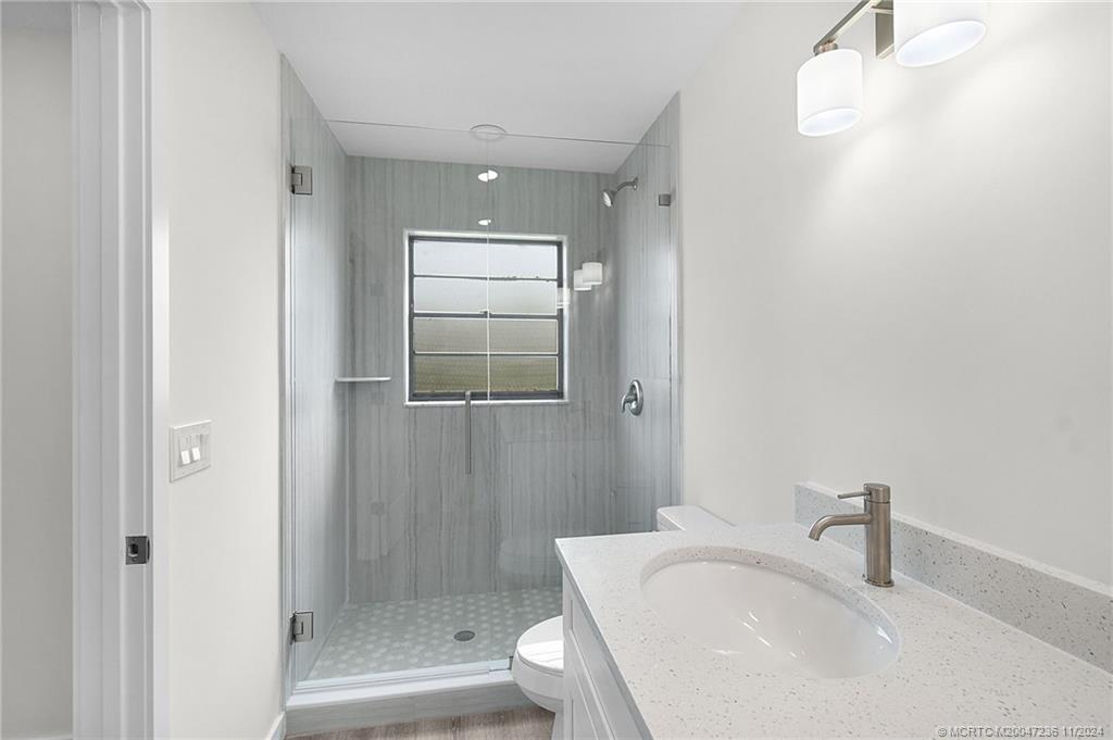 5635 Southeast Miles Grant Road Stuart, FL 34997 - Photo 33 of 73 a bathroom with a sink and a tub