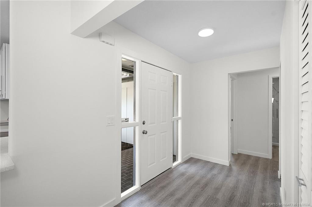 5635 Southeast Miles Grant Road Stuart, FL 34997 - Photo 34 of 73 a view of an empty room with wooden floor
