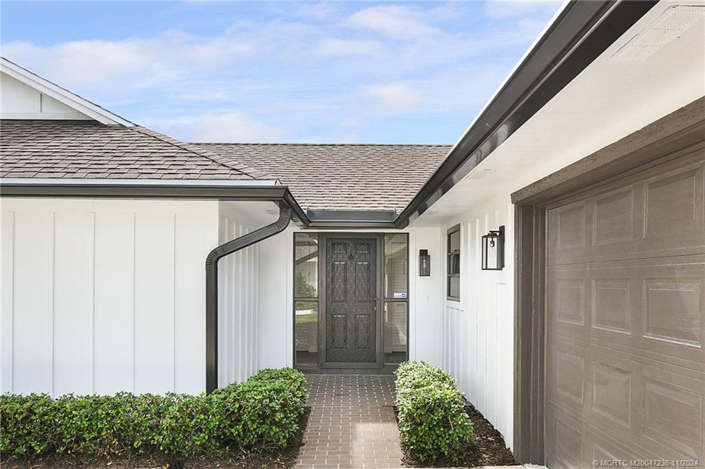 5635 Southeast Miles Grant Road Stuart, FL 34997 - Photo 4 of 73 a view of house with garden