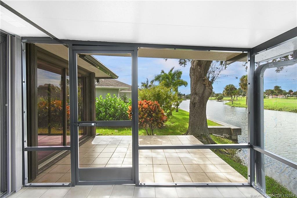 5635 Southeast Miles Grant Road Stuart, FL 34997 - Photo 41 of 73 a view of a glass door with a floor to ceiling window with wooden floor
