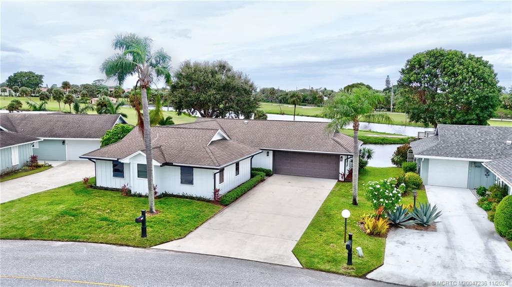 5635 Southeast Miles Grant Road Stuart, FL 34997 - Photo 44 of 73 a aerial view of a house with a yard and potted plants