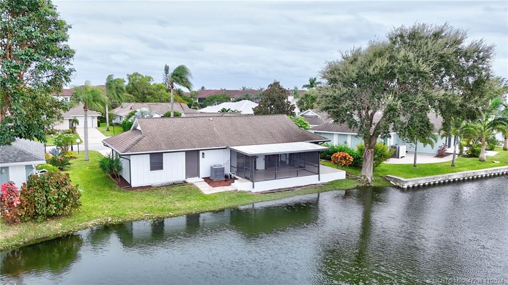 5635 Southeast Miles Grant Road Stuart, FL 34997 - Photo 45 of 73 an aerial view of a house with swimming pool and a yard