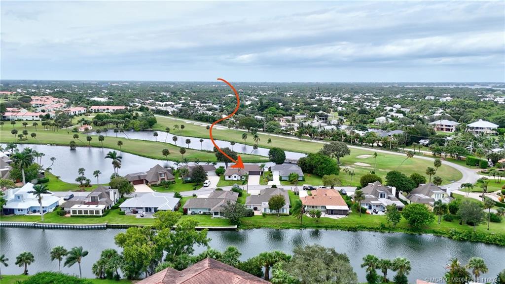 5635 Southeast Miles Grant Road Stuart, FL 34997 - Photo 50 of 73 an aerial view of lake residential houses with outdoor space and swimming pool