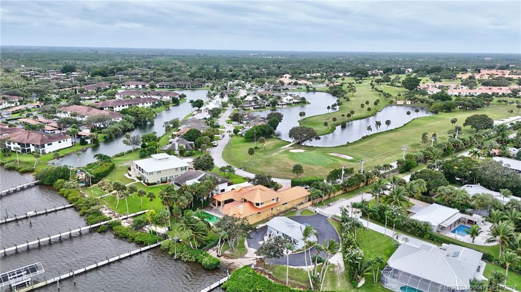 5635 Southeast Miles Grant Road Stuart, FL 34997 - Photo 59 of 73 an aerial view of a city with lots of residential buildings