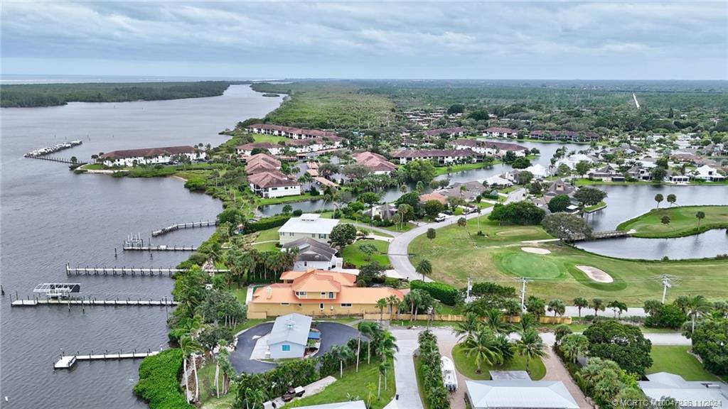 5635 Southeast Miles Grant Road Stuart, FL 34997 - Photo 60 of 73 an aerial view of residential houses with outdoor space