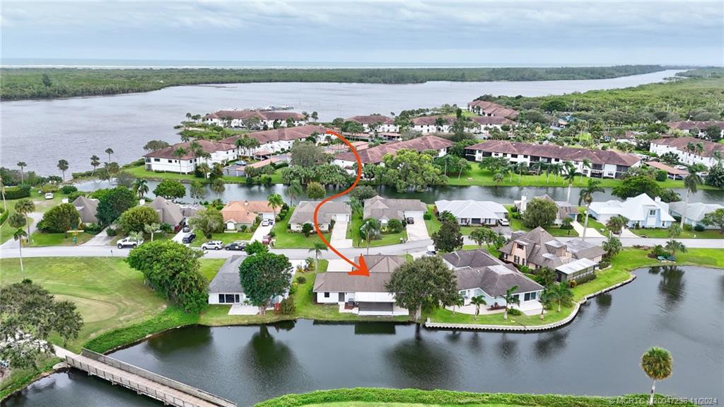 5635 Southeast Miles Grant Road Stuart, FL 34997 - Photo 67 of 73 an aerial view of a house with a lake view