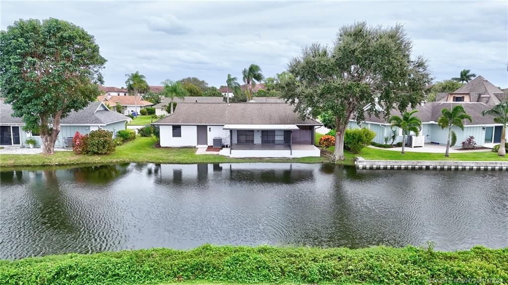 5635 Southeast Miles Grant Road Stuart, FL 34997 - Photo 69 of 73 an aerial view of residential houses with outdoor space and lake view