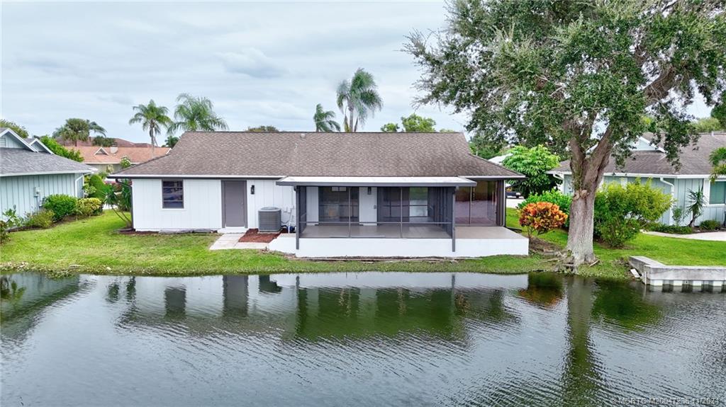 5635 Southeast Miles Grant Road Stuart, FL 34997 - Photo 70 of 73 a front view of a house with garden