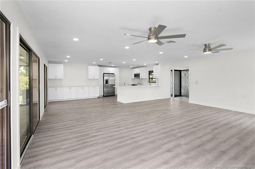 5635 Southeast Miles Grant Road Stuart, FL 34997 - Photo 9 of 73 a view of a kitchen with a sink and a refrigerator