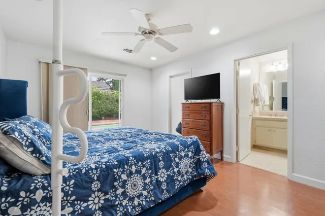 a bedroom with a bed and a flat screen television