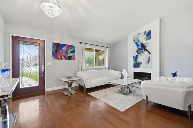 a living room with furniture a fireplace and a window
