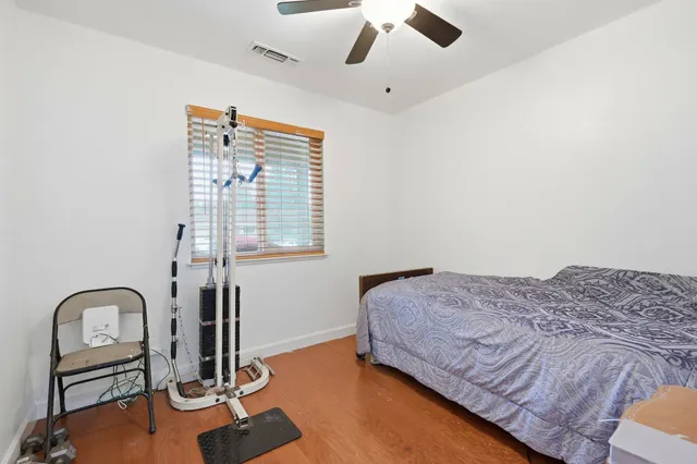 a bedroom with a bed and ceiling fan