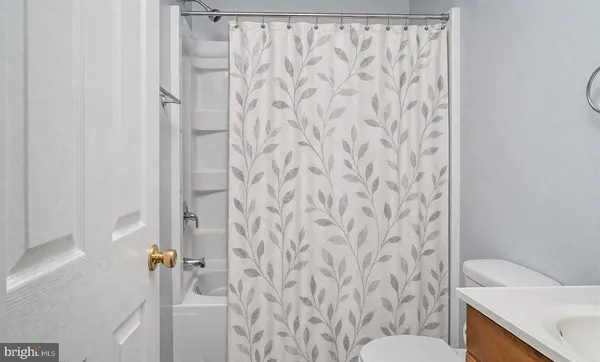a bathroom with a toilet and a shower curtain