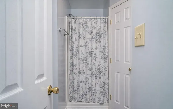 a bathroom with a shower curtain and a curtain