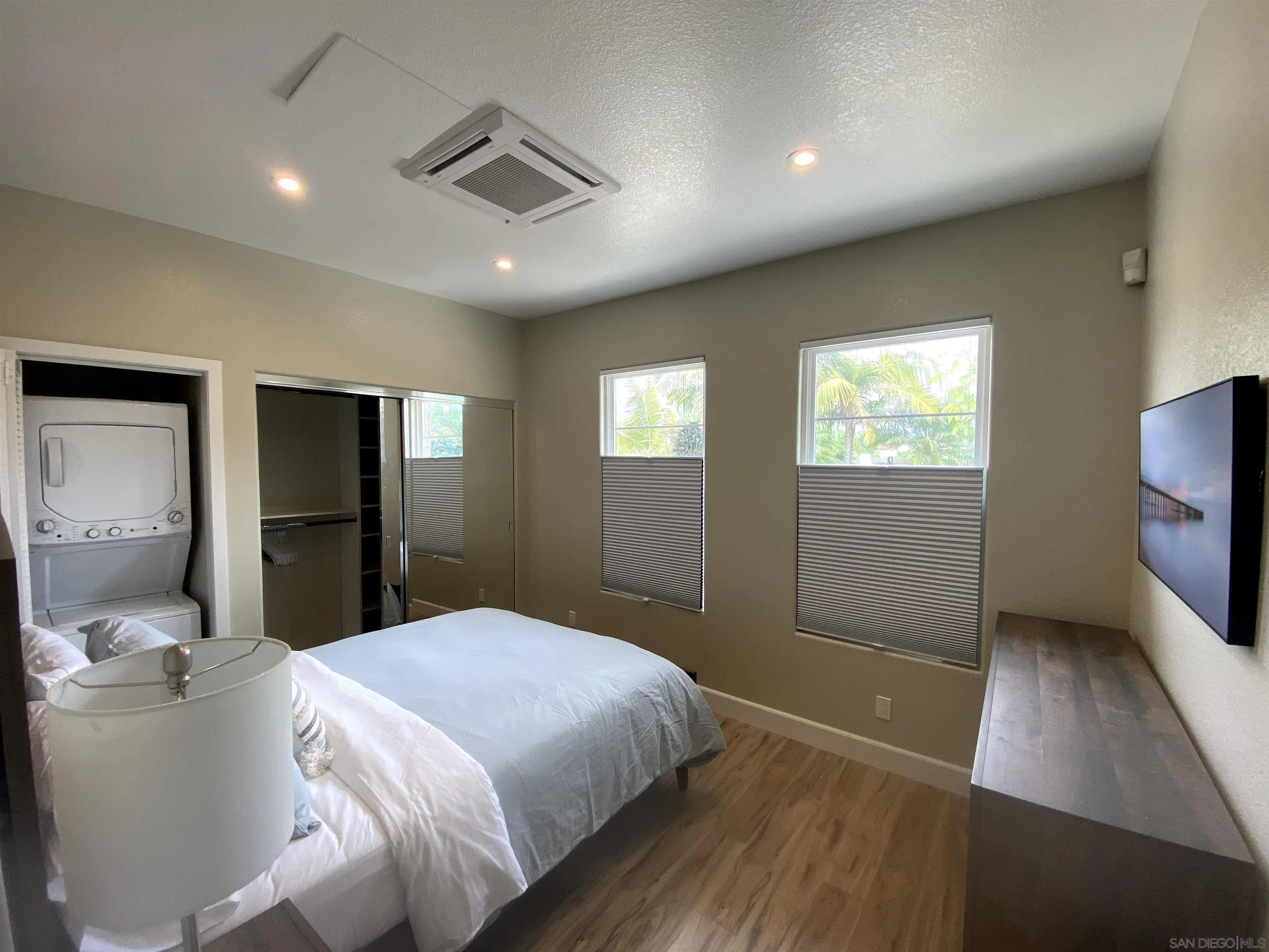 1774 Dove Lane Carlsbad, CA 92011 - Photo 12 of 25 a bedroom with a bed and a flat tv screen on dresser