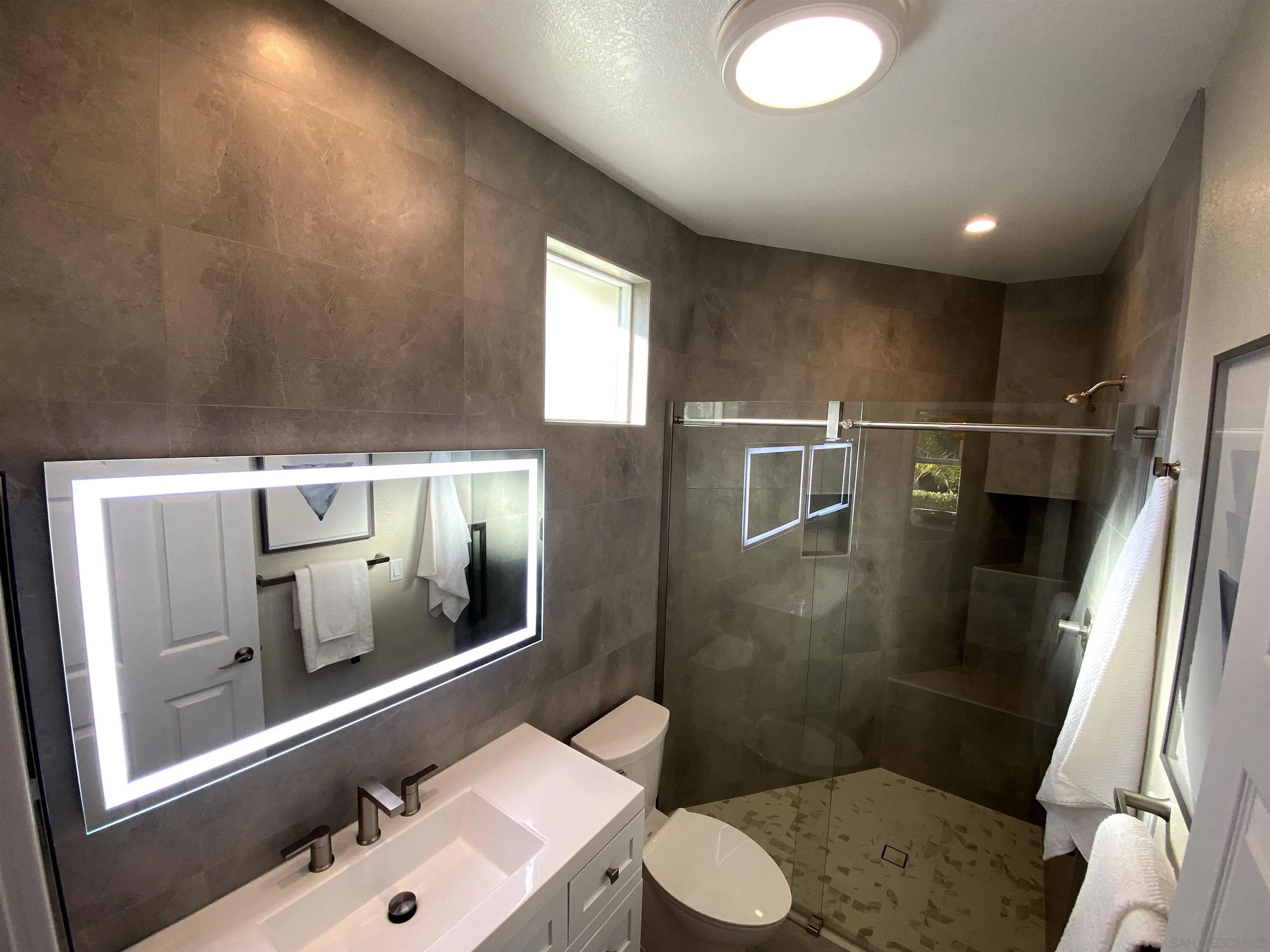 1774 Dove Lane Carlsbad, CA 92011 - Photo 14 of 25 a bathroom with a sink a toilet a mirror and shower