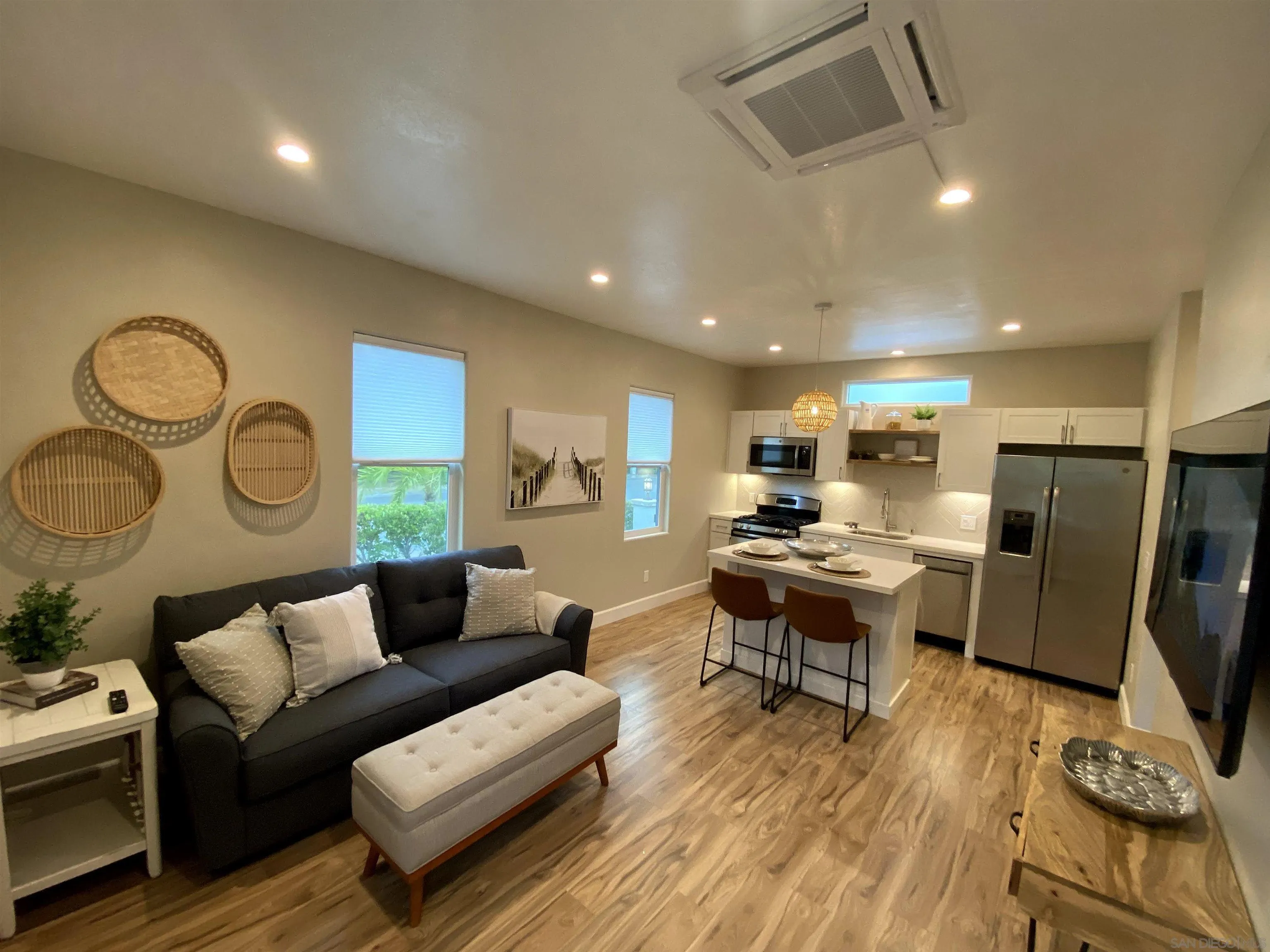 1774 Dove Lane Carlsbad, CA 92011 - Photo 3 of 25 a living room with furniture kitchen view and a wooden floor