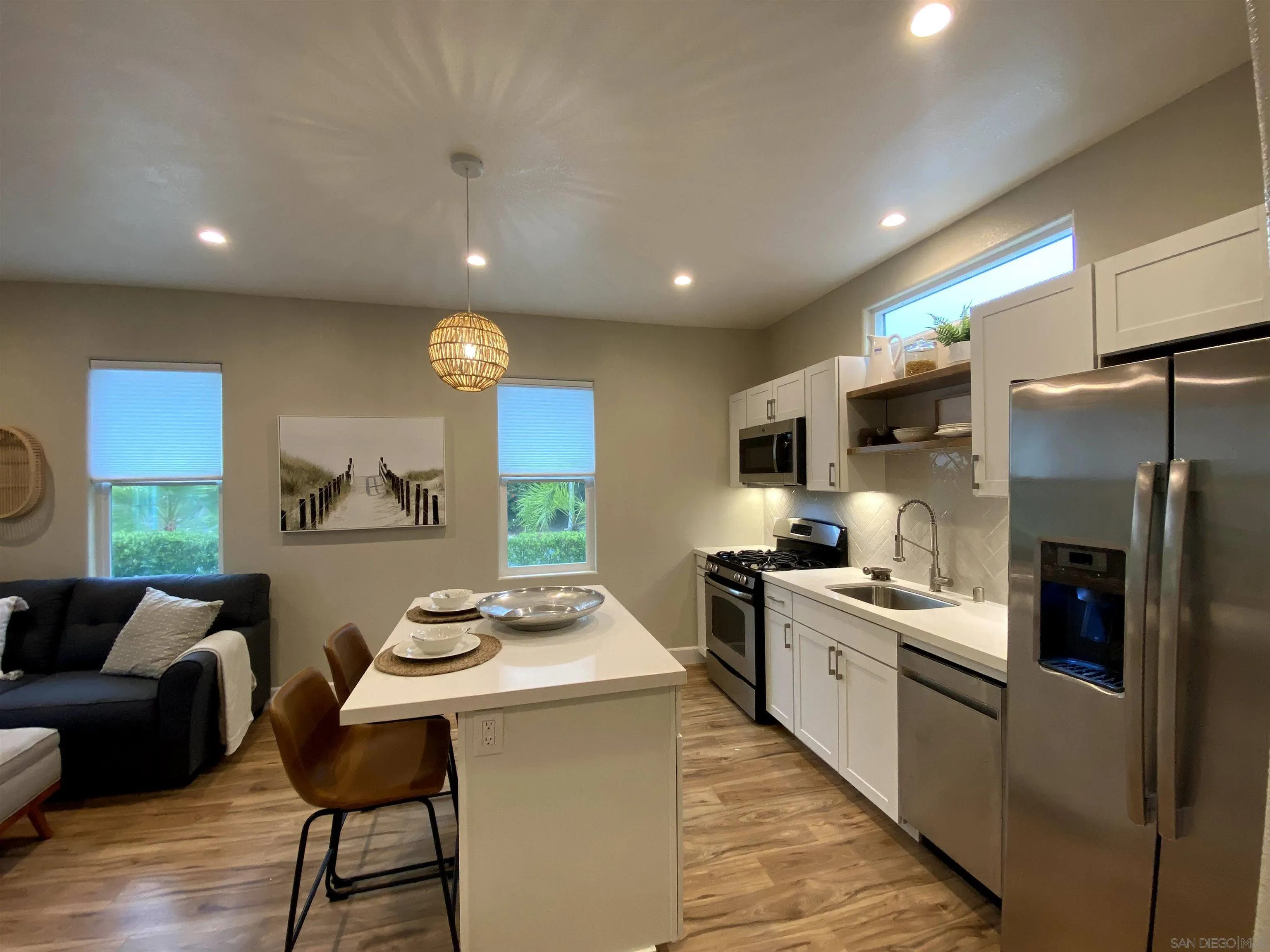1774 Dove Lane Carlsbad, CA 92011 - Photo 6 of 25 a kitchen with stainless steel appliances a refrigerator a stove a sink a couch and chairs