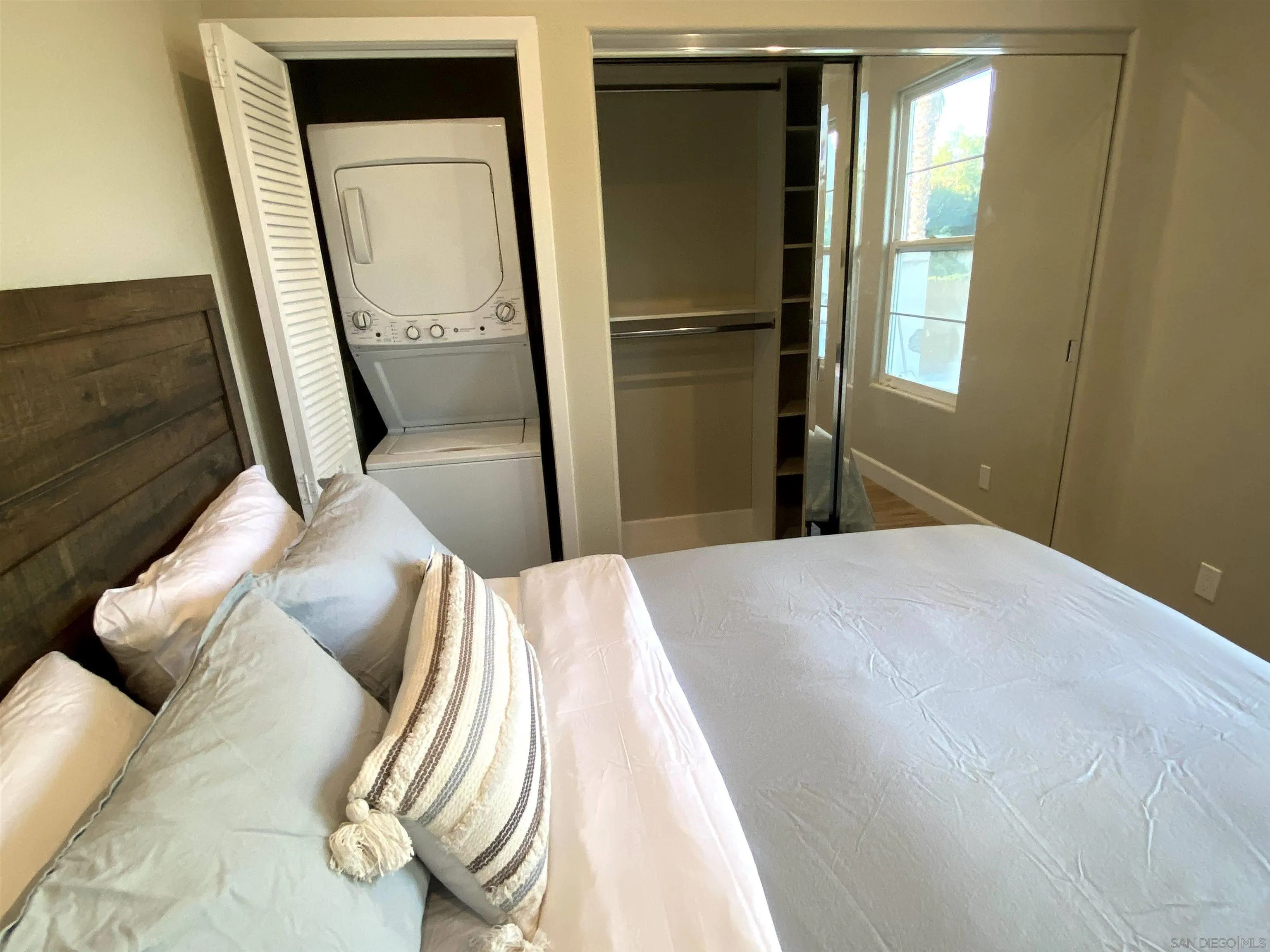 1774 Dove Lane Carlsbad, CA 92011 - Photo 9 of 25 a bedroom with a bed and a mirror