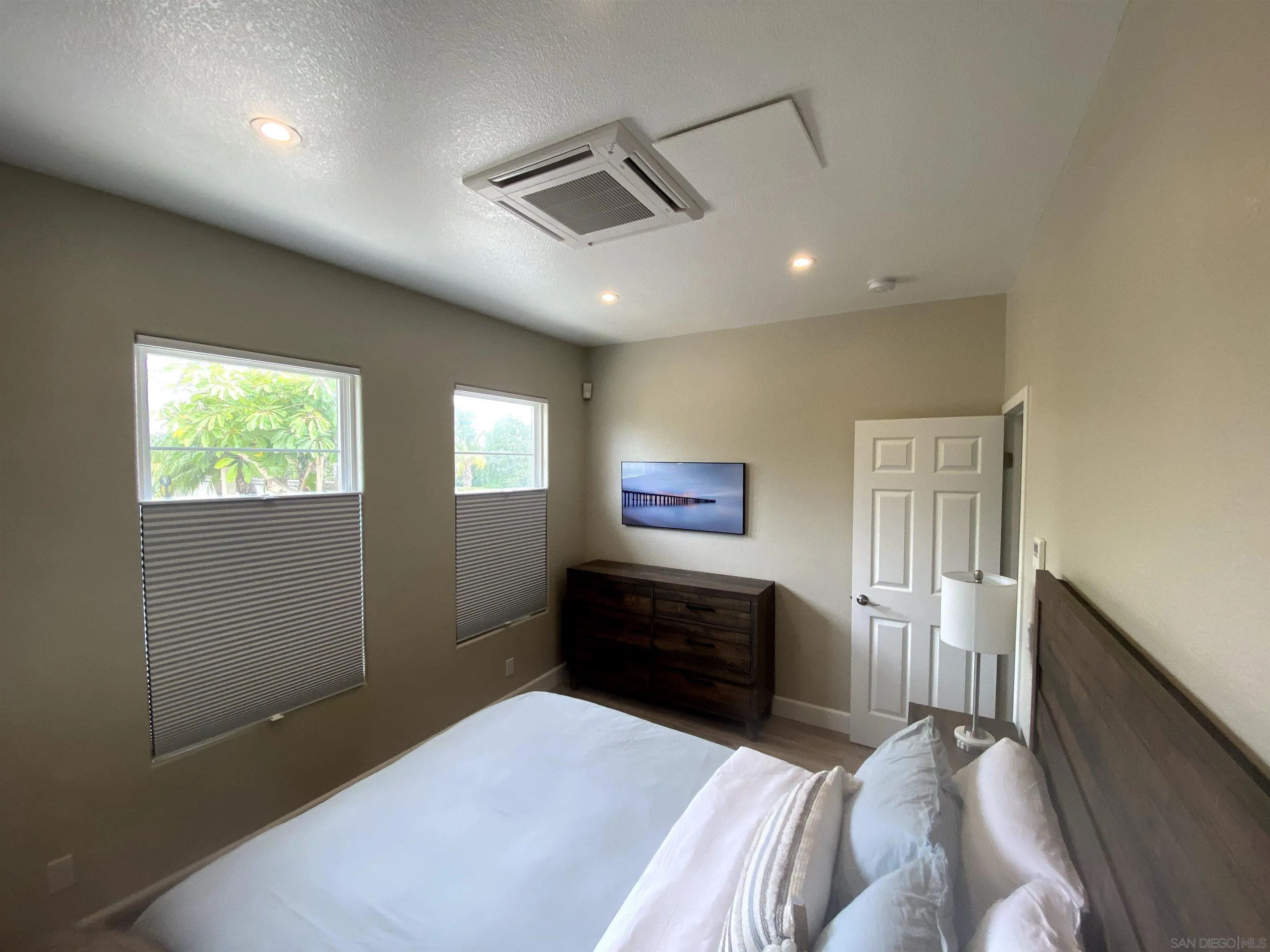 1774 Dove Lane Carlsbad, CA 92011 - Photo 10 of 25 a bedroom with a bed and a dresser