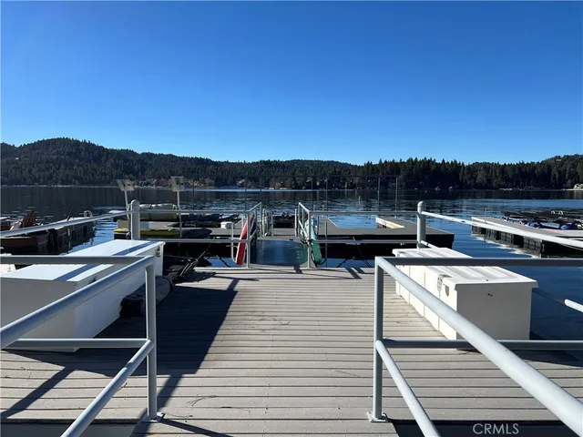 a view of a roof deck with couches and sky view