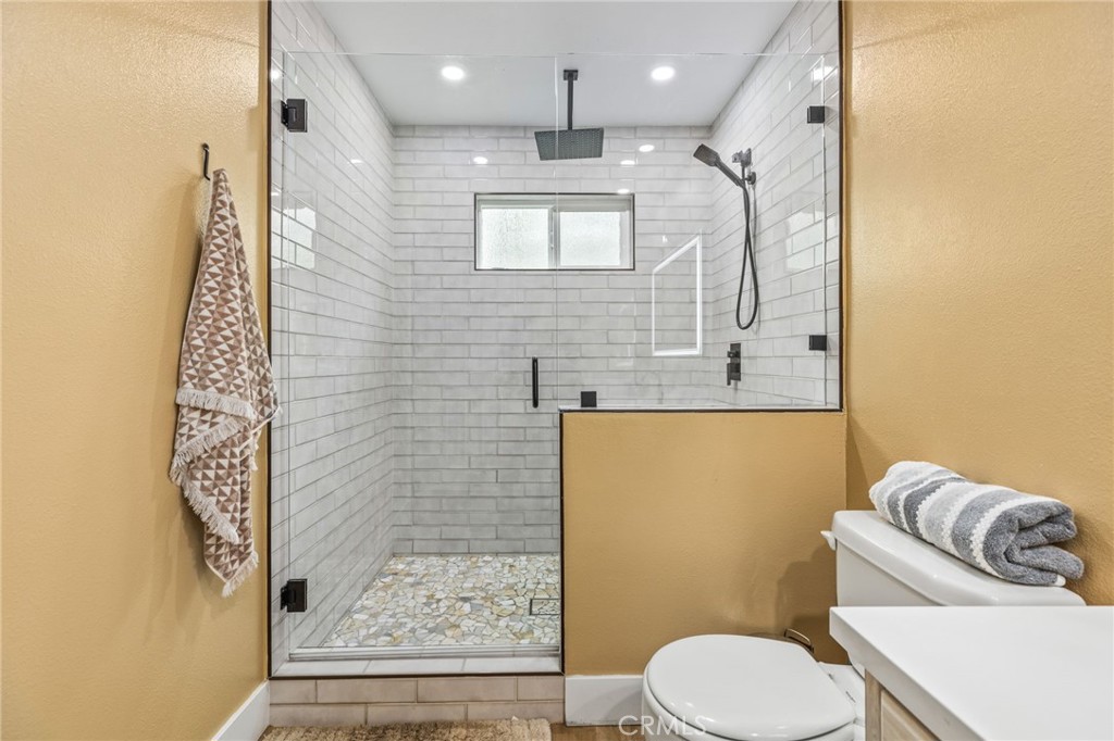 3998 Bluff Street Norco, CA 92860 - Photo 25 of 74 a bathroom with a toilet sink and mirror