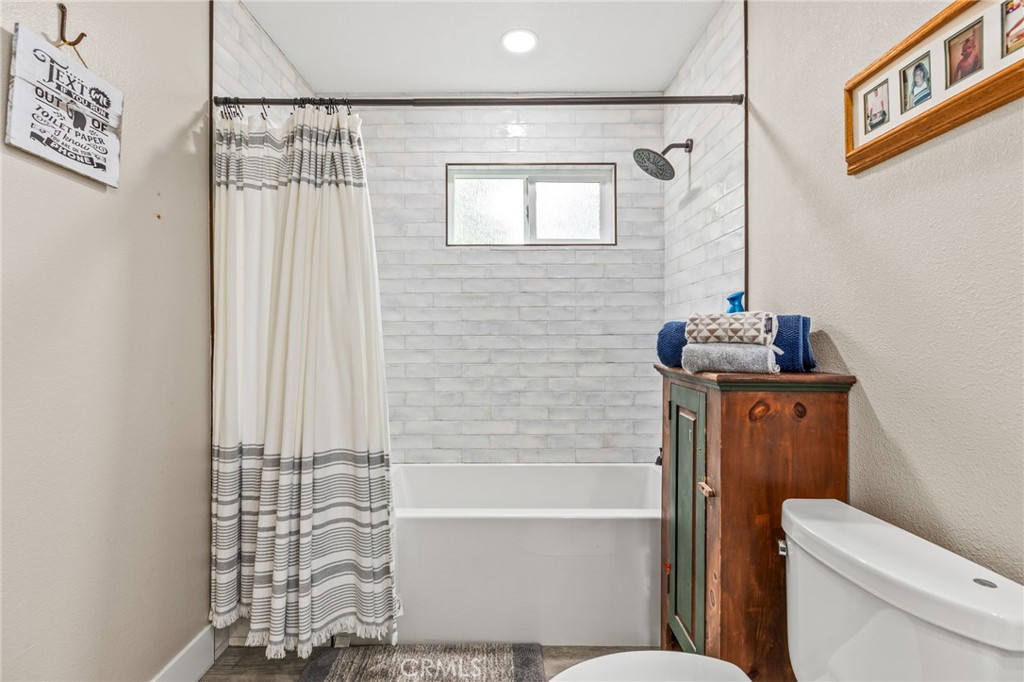 3998 Bluff Street Norco, CA 92860 - Photo 27 of 74 a bathroom with a toilet a sink and bathtub