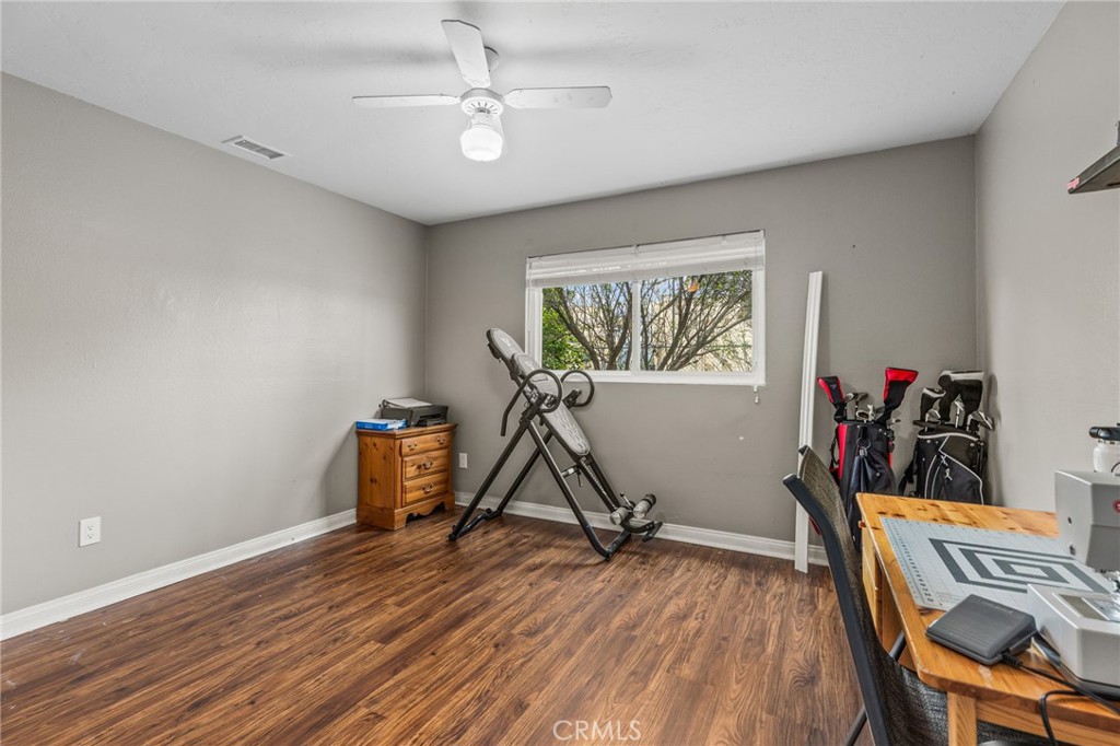 3998 Bluff Street Norco, CA 92860 - Photo 28 of 74 a view of room with wooden floor and ceiling fan