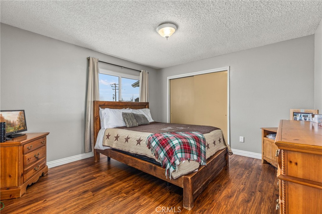 3998 Bluff Street Norco, CA 92860 - Photo 30 of 74 a bedroom with a bed and wooden floor
