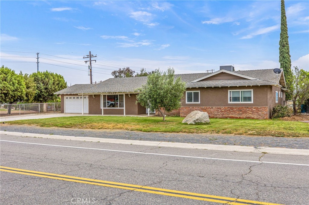 3998 Bluff Street Norco, CA 92860 - Photo 4 of 74 a view of a house with a big yard and palm trees