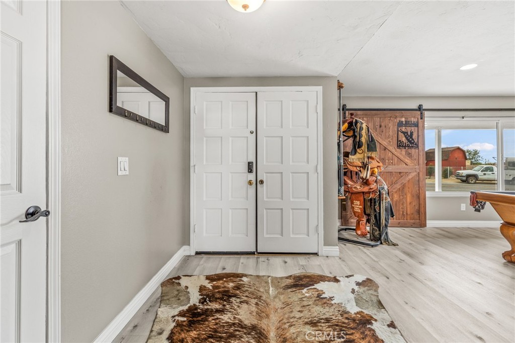 3998 Bluff Street Norco, CA 92860 - Photo 7 of 74 a view of a livingroom with wooden floor and white walls