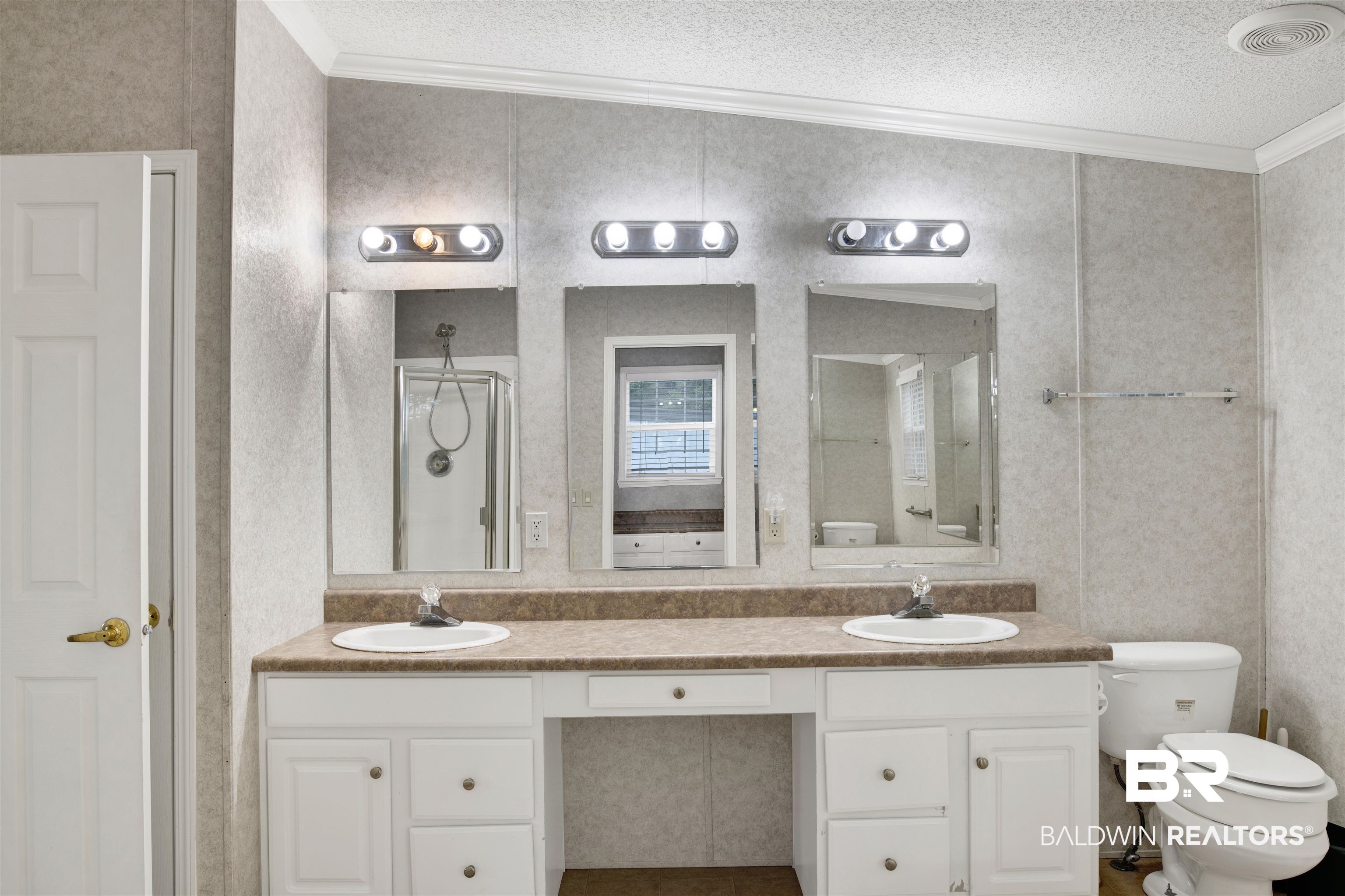 25700 County Road 71 Robertsdale, AL 36567 - Photo 22 of 40 Full bath featuring ornamental molding, double vanity, and a textured ceiling